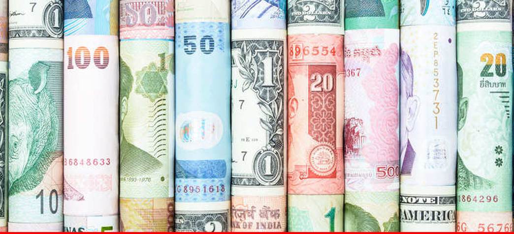  An image of rolled up paper money from various countries, representing the global currency markets.